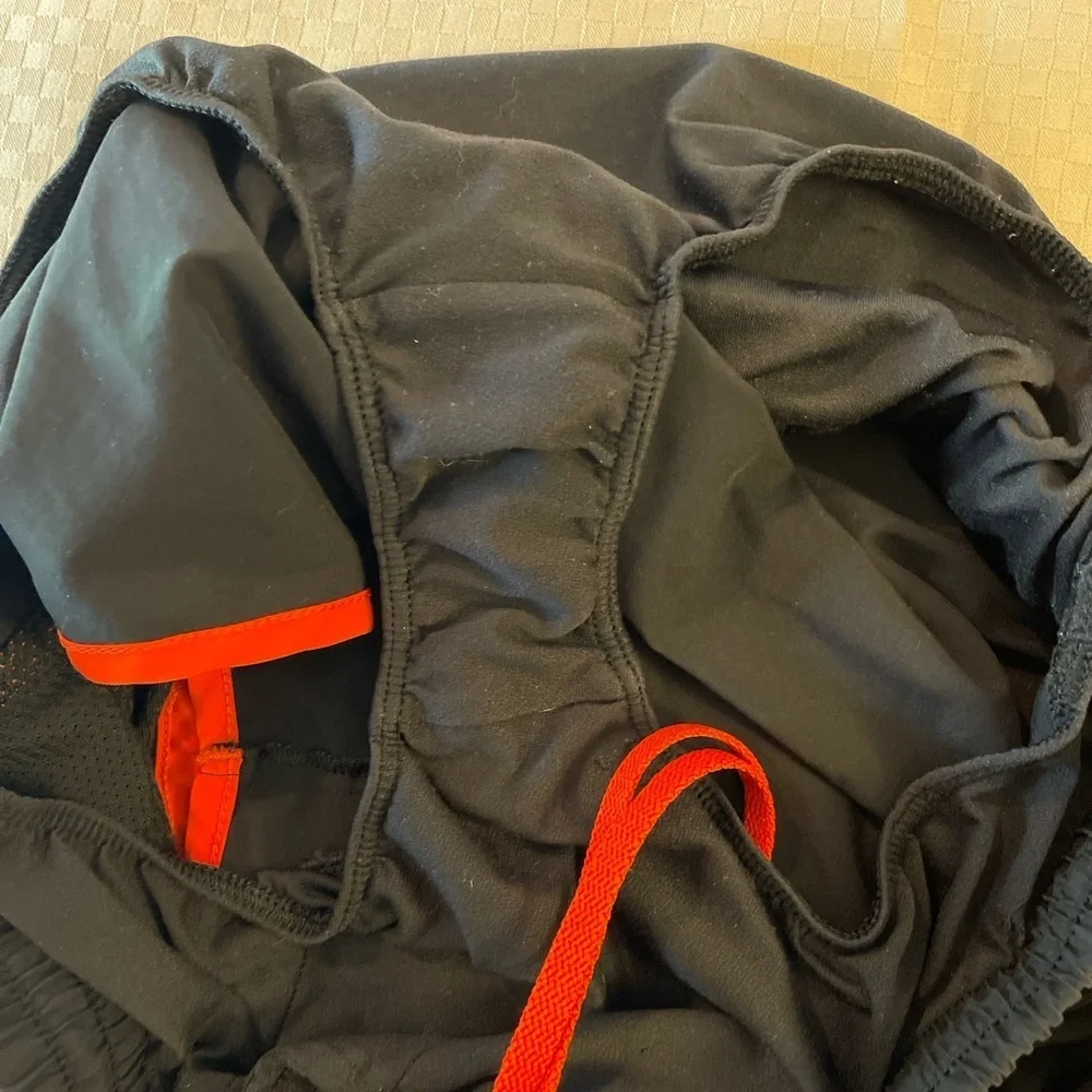 Under Armor black w/orange trip lined 3” inseam women’s running shorts. Size S. - Picture 7 of 7